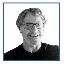 A black and white photo of a man with glasses.