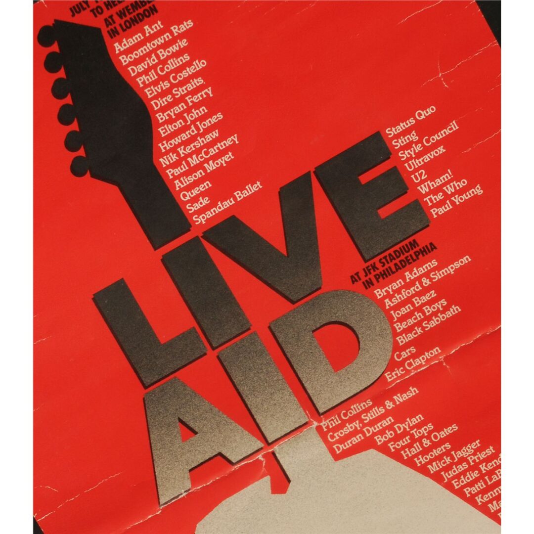 A red poster with the words live aid written in black.